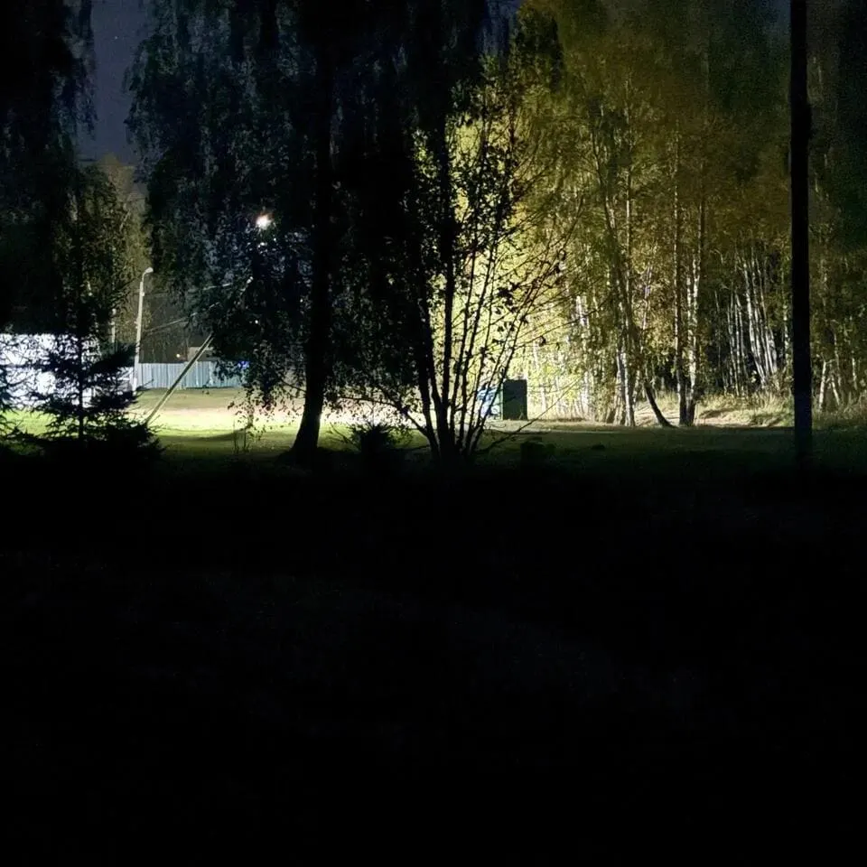 Ярко освещённое здание среди тёмной местности